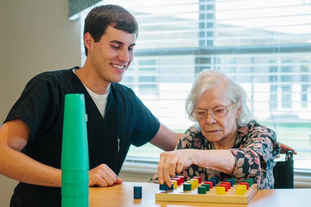 A woman is going through physical therapy at a short term care facility